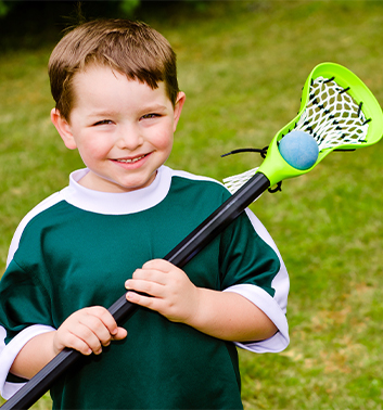 Lacrosse boy smiling racket ball 353x378 1