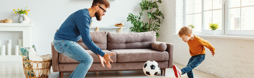 Child at home playing football inside