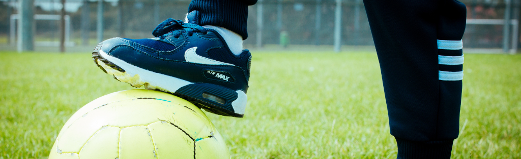 Child with foot on football