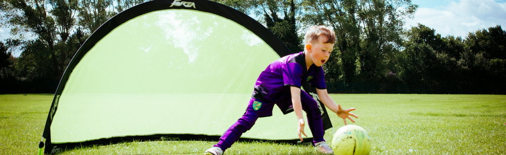 Child with saving a goal while playing football