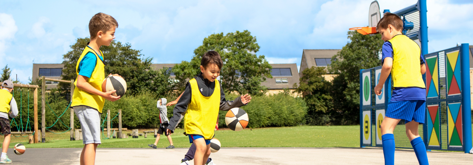 Children playing basketball at a Premier Education summer Holiday Camp