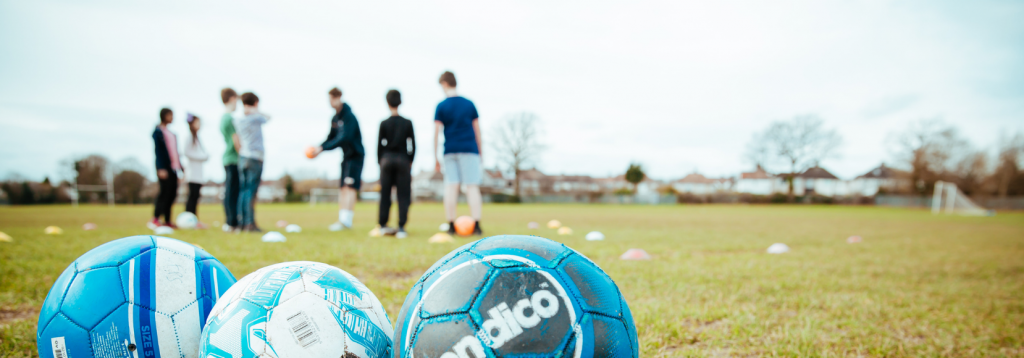 Children playing football at a Premier Education Holiday Camp