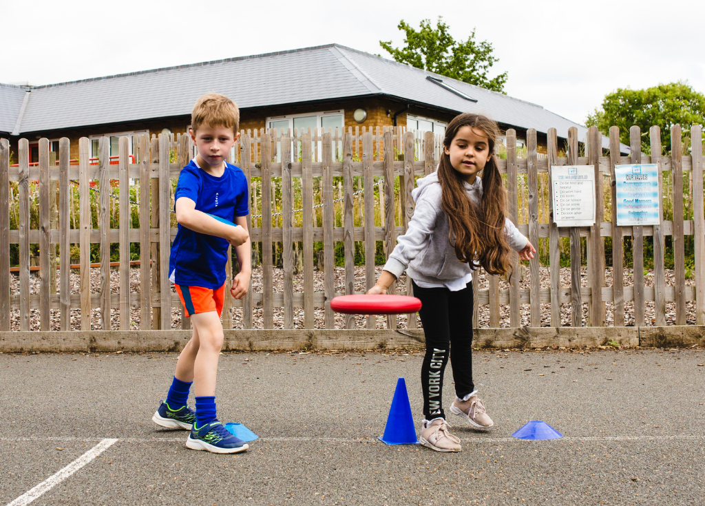 Children playing frisbee at a Premier Education Summer Holiday Camp