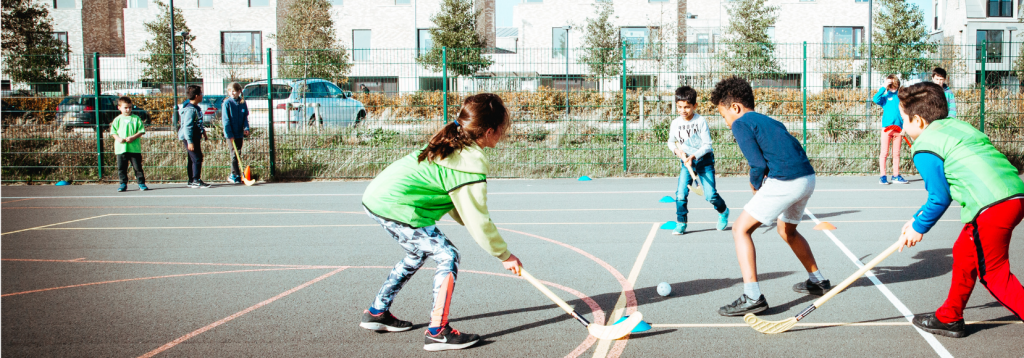 Children playing hockey at a Premier Education Holiday Camp 2