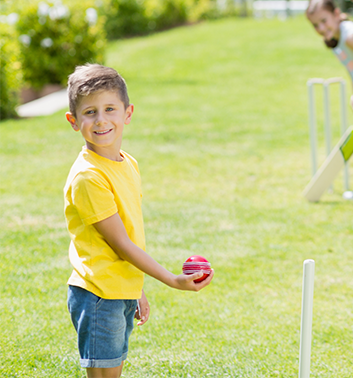 Cricket boy holding ball 353x378 1