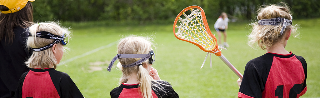 Lacrosse girls watching sport 1024x314 1