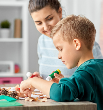 Child crafting a pine cone squirrel