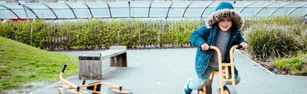 A boy having fun on a balance bike during a crucial break for play and outdoor learning.