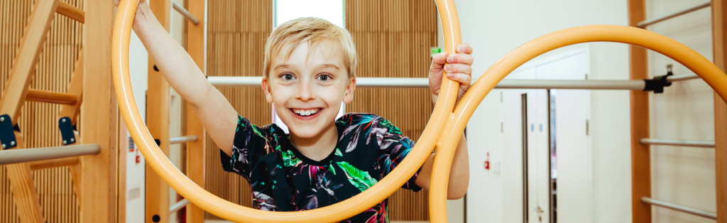 Smiling boy enjoying Premier Education Gymnastics club.