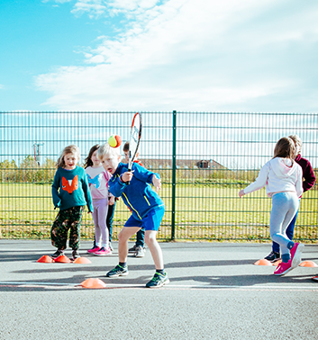 Tennis group boy hitting racket 353x378 1