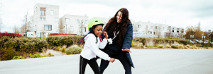 Activity professional teaching a child to skate